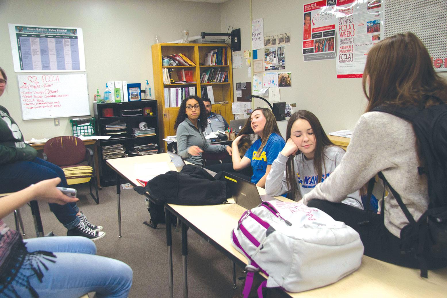 During a work night before the district STAR event competition in Tonganoxie, sophomore members Destiny Downing, Jade Byer and Kaylan Benton prepare to present their projects.