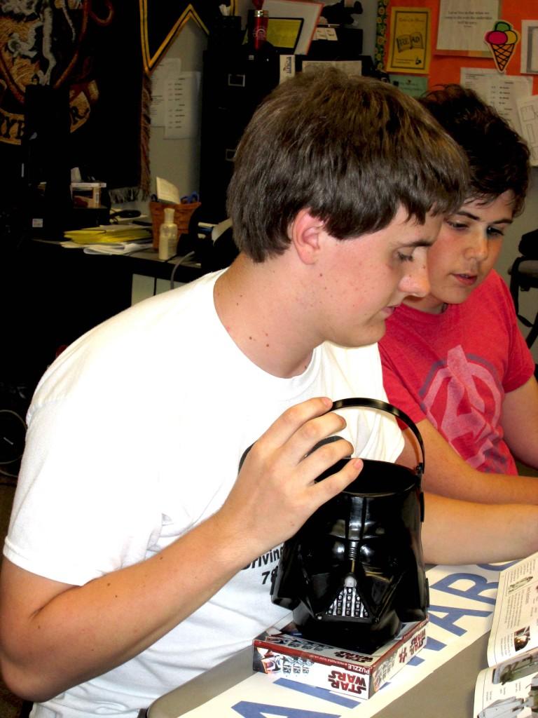 Weapons Master Sampson Goodwin (10) holds the Darth Vader communal candy basket and helps a club neophyte. 