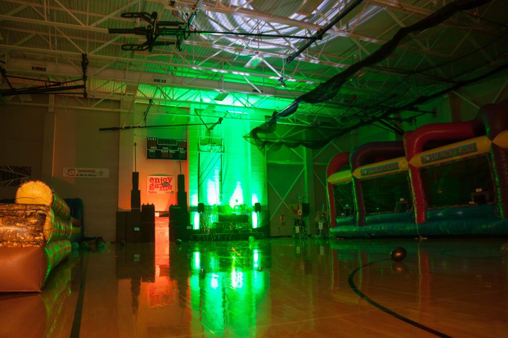 A green light illuminates the small gym before the Homecoming dance begins.