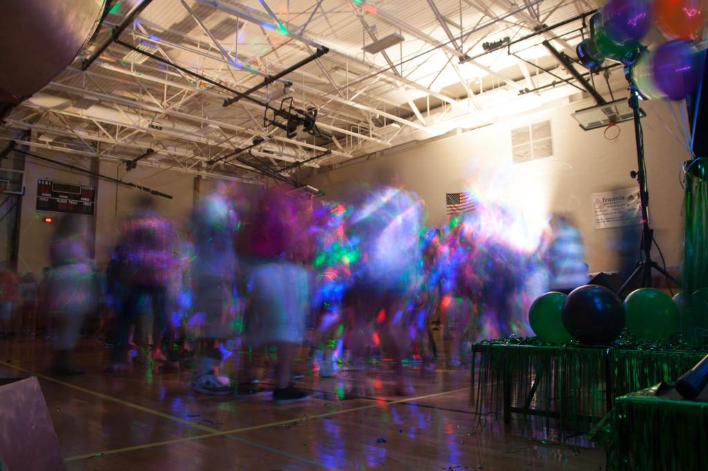 A+cluster+of+students+blur+into+a+mass+of+excitement+and+fun+during+the+Homecoming+dance.