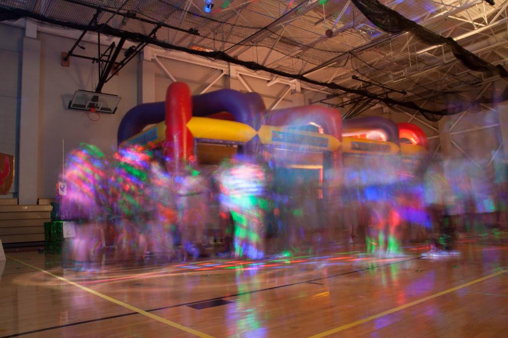 Colorful lights brighten the small gym during the Homecoming Dance.