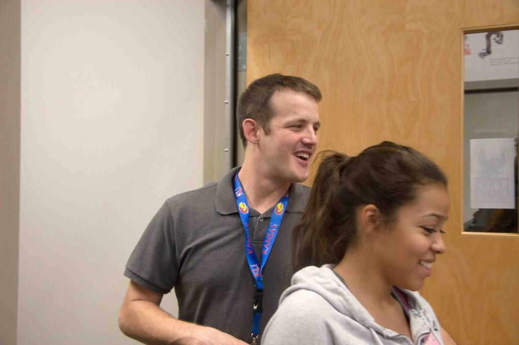 New debate coach Jason Moore smiles as he holds open the door for junior Lexci Kimball. He was hired three weeks into the season after the departure of Patty Newkirk.