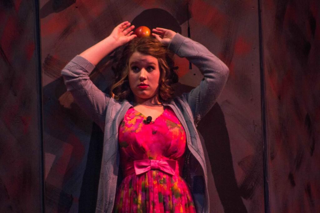 Senior Madeline Chestnut balances an apple on her head during The Pajama Game. Chestnut played the role of Babe Williams, the head of the Grievance Committee.