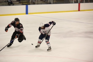 Junior Anthony Hummel, on right, squares off against an opponent during a Midwest High School Hockey League game in 2013. Hummel is one of the four student hockey players the Free Press found. 