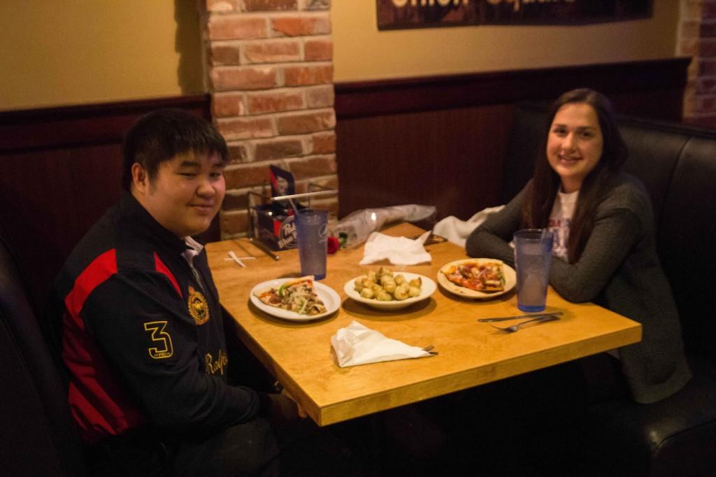 Juniors Parkin Srisutiva and Isabelle Haake sit down to dinner at Johnny Bruscos Pizza.