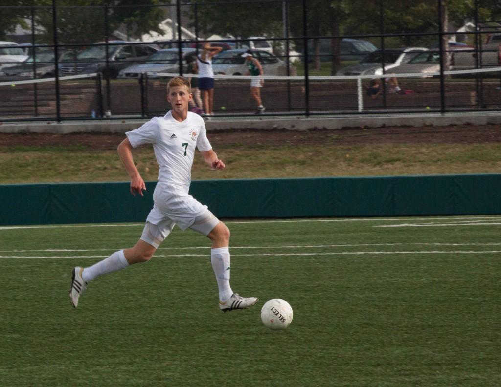 Senior Chris Allen chases down the ball at a game against Shawnee Mission East. Allen recently committed to play soccer at the Richmond International Academic and Soccer Academy (RIASA) in Leeds, England.