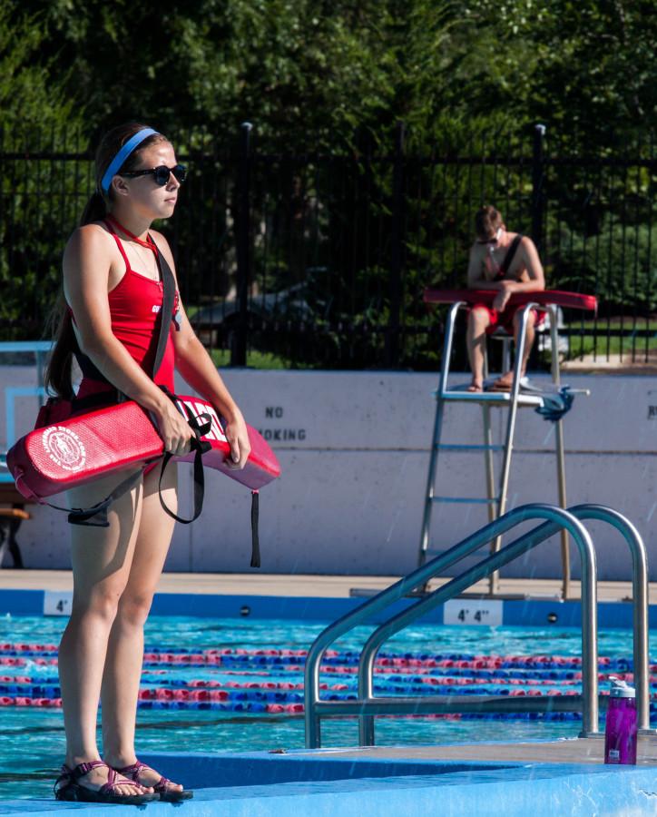 Senior Elyse Boxberger perches at her post as a lifeguard at the Lawrence Outdoor Pool.