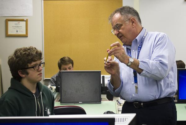 Sitting at his desk during his drafting I class, freshman William Orr watches Mr. Williams as he goes over parts of a drafting pencil. Students spent the first couple weeks of the semester with substitutes while the school looked for a permanent replacement for Don Clancy, the previous instructor. I heard people talk [about Clancys retirement], but I didnt find out until the beginning of the semester, Orr said.