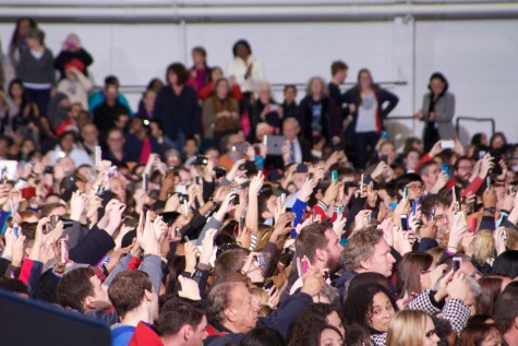 Members of the audience snap pictures of President Barack Obama as he takes the stage. Obama spoke at the University of Kansas in Anschutz Sports Pavilion on Jan. 22.