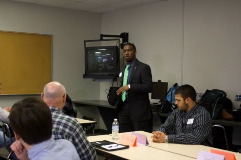 Speaking to a room of male students and community leaders, assistant principal Keith Jones begins the Ambassador program's first formal meeting. Students discussed their school performance and involvement with their assigned mentors.