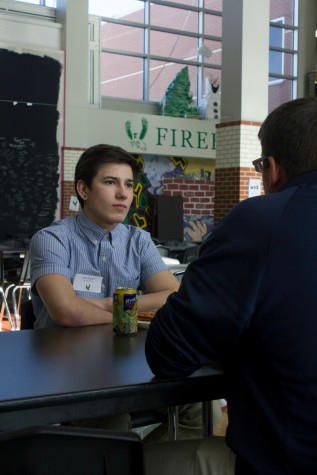 During a lunch meeting for the Ambassador program, sophomore Arlo March talks with Colby Wilson, director of the Lawrence Boys and Girls Club. The program partners adolescent boys with community businessmen to discuss future career paths. "[The program] is definitely a learning experience for [students]," March said. "It's just cool to interact with adults."