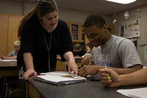 Junior Khaury El-Amin works with science teacher Mattithyah Tillotson during his chemistry class. After Brad Simon passed away last December, Tillotson was chosen to replace him. El-Amin is glad that there is a replacement that is able to fulfill the standards set by Simon.