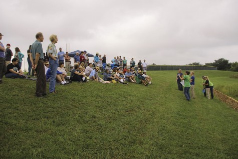 Bystanders gather to learn about the prairie restoration project behind Free State.