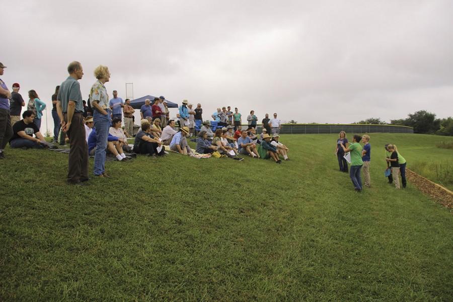 Bystanders+gather+to+learn+about+the+prairie+restoration+project+behind+Free+State.+