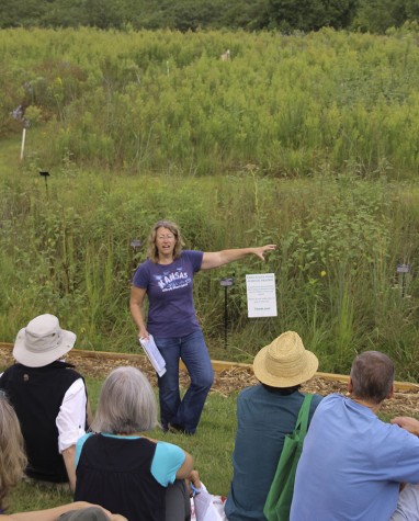 Free State science teacher shows the prairie at the prairie restoration walk through. 