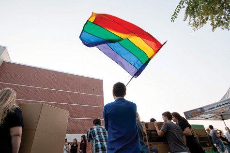 Promoting Free State's Gay-Straight Alliance, junior Will Lenz waves the pride flag during the Club Fair on August 31. GSA has been a club since 2005.