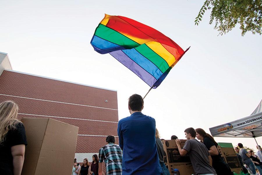 Promoting Free States Gay-Straight Alliance, junior Will Lenz waves the pride flag during the Club Fair on August 31. GSA has been a club since 2005.