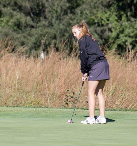 Watching competitors read their putt, sophomore Tori Hoopingarner waits to move onto the next hole. Hoopingarner first got interested in golf because of her dad and grandpa,
