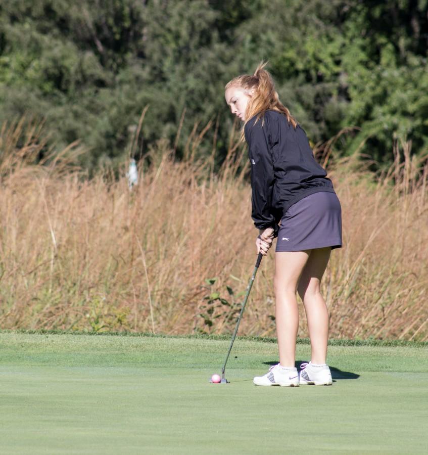 Watching competitors read their putt, sophomore Tori Hoopingarner waits to move onto the next hole. Hoopingarner first got interested in golf because of her dad and grandpa, They were really into golf, so I tried it out and I liked it, Hoopingarner said.
