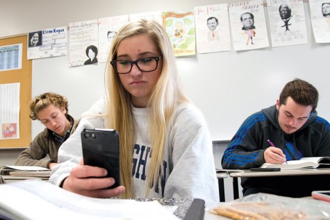 During class, senior Holly Hummel scrolls through her Instagram feed. 