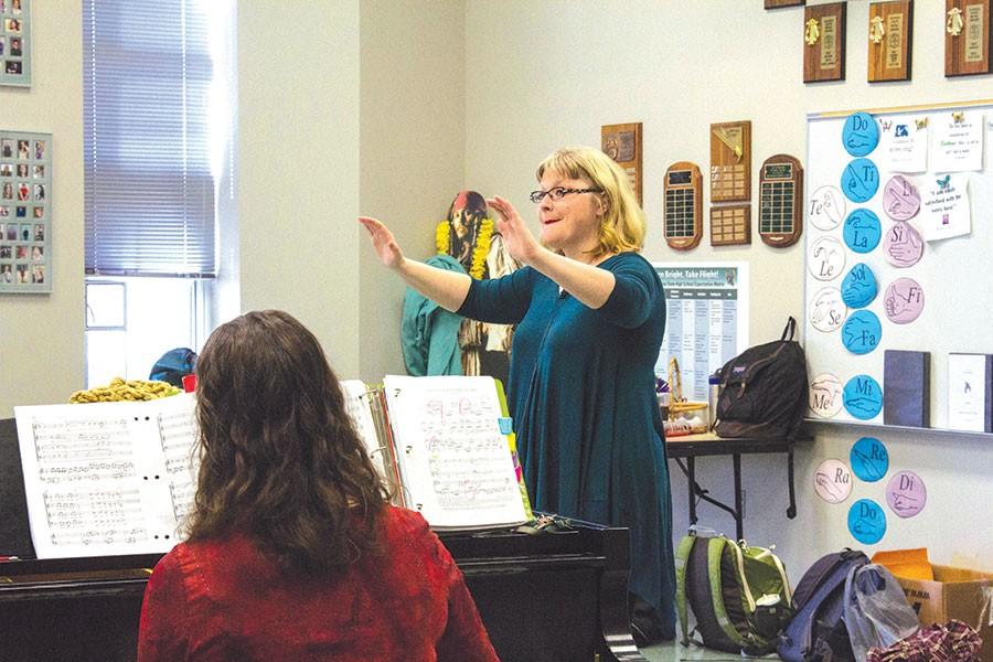 During Concert Chorale, Hilary Morton conducts her students as they sing White House. Morton has been a choir director at Free State for nine years. I have Chamber Singers Monday nights, Feminist Club every other Wednesday and now with Encore, I work Wednesday and Thursday nights and come to rehearsals throughout the weekend, Morton said. 