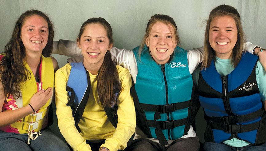 Sophomores Sydni Beeley, Maggie Ziegler, Caroline Kirk and Quincy Beeler recreate a photo from a day at the lake circa 2009. “We are all still friends, but probably not as close as we were just because we are all involved in different activities now,” Beeley said.