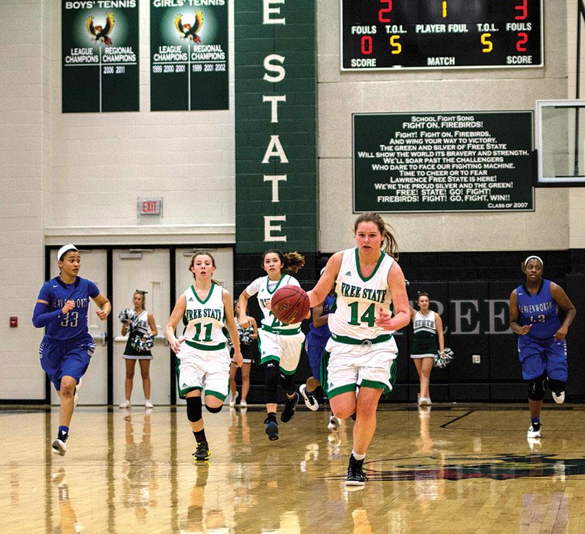 Running down the court, junior Madison Piper and senior Caiti Schlesener look to score against Leavenworth on January 12. 