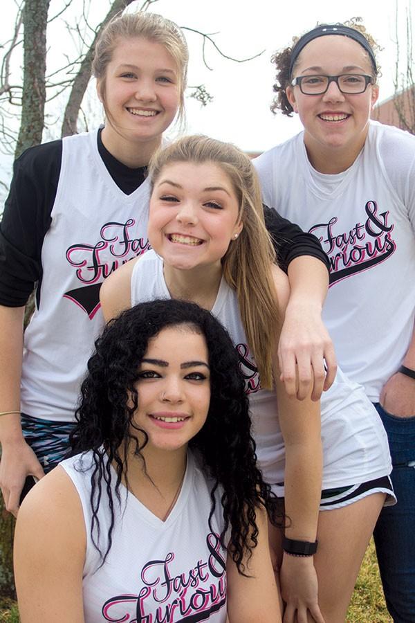 Dressed in their old softball gear, junior
Jasper Hawkins, freshman Lauryn Jones, sophomore Parker Delfelder and junior Kaylee Brown recreate a photo. The girls played on the Fast and Furious softball team when they were in middle school. “My favorite part about being on the team was probably the leadership role I had because I was one of the oldest,” said Hawkins.