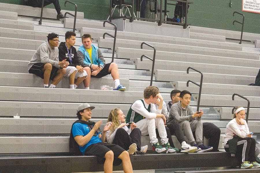 During a girls basketball game, juniors Noah Kema, Payton Gannaway, senior Aric Trent, junior Wesley Zhang and sophomore Reagan Sullivan look at their phones.
A noticeably larger amount of students attend the boys basketball games than the girls.