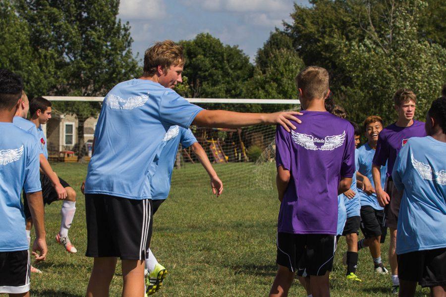 Sophomore Bayn Schrader consults his teammate Jacob Appleman during a drill. All soccer players started conditioning only two weeks after school ended in May.