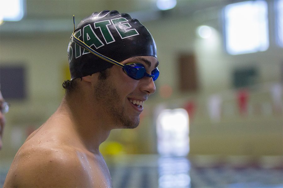 Senior Jordan Portela talks with a teammate before practice. Portela has been swimming competitively for seven years