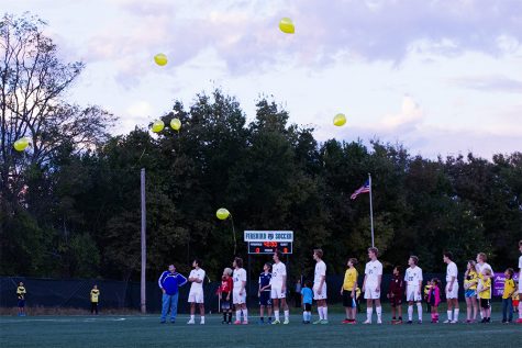 Senior Tom Reno, junior Samuel Six, sophomore Drew Covington, junior Jackson Campbell, freshmen Pete Junge, junior Jared Lieberman, senior Owen Kapfer and senior Santiago Trejo release their yellow balloons following the moment of silence. Yellow was Amanda Kapfer's favorite color .