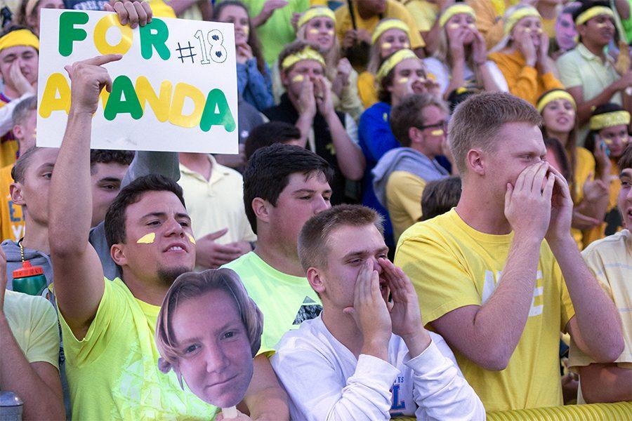 Senior Blake Hoffman, Cooper McHatton and Aaron Funk cheer for Owen Kapfer during the city showdown. 