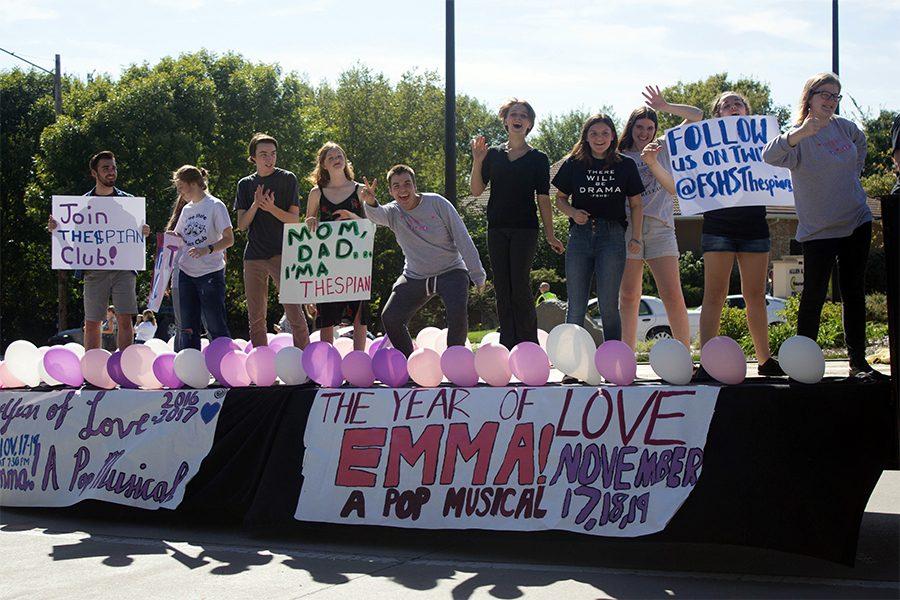 Eli Bork, Anna Bial, Chris Pendry, Morgan McReynolds, Ilya Schaeffer, Calliope Taylor, Anina Supernaw, Rowan Plinsky, Eliza Hasse-Divine hold signs and cheer towards spectators during the homecoming parade. There were hundreds of spectators during this years parade.