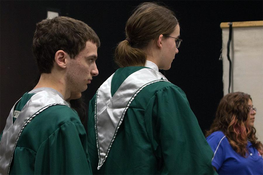 Seniors Nicholas Sickels and Benjamin Gotto wait in line for senior pictures. 