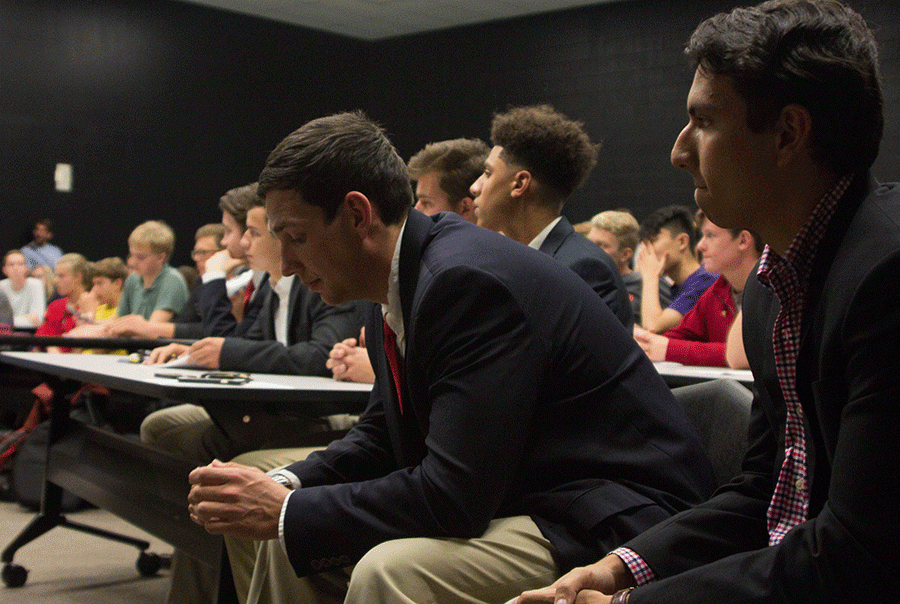 Young Republicans club members Dale Miller and Sayuz Thapa watch the debate. Young Republicans Club members arrived at the debate wearing suit jackets.