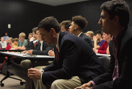 Young Republicans club members Dale Miller and Sayuz Thapa watch the debate. Young Republicans Club members arrived at the debate wearing suit jackets.