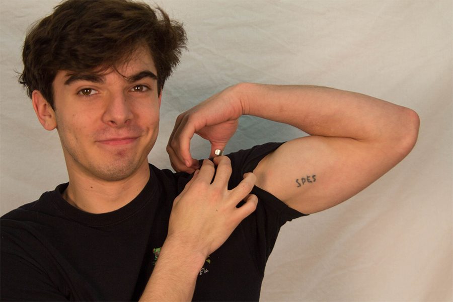 Dorian Vance displays his tattoo.  Spes means hope in Latin.