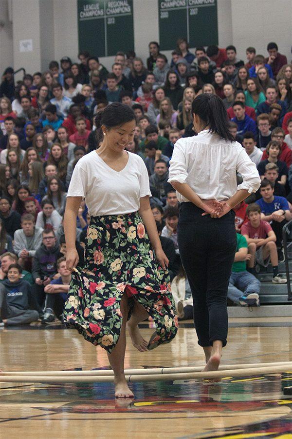 Claire Fontaina and Nichol Ahn participate in Tinikling, a traditional Filipino form of dance. 