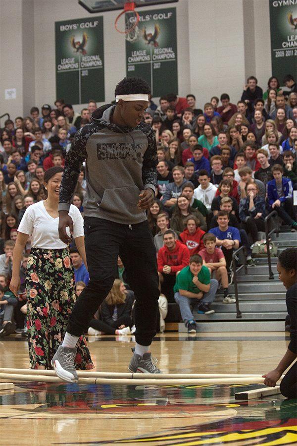 Cameron Clark tries to hop between the two bamboo rods during Tinikling.