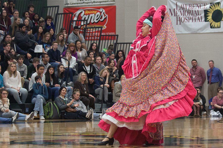 Raising her arms, sophomore Mariela Martinez performs El Ardillo. The diversity assembly was on Feb. 2 in the big gym. 