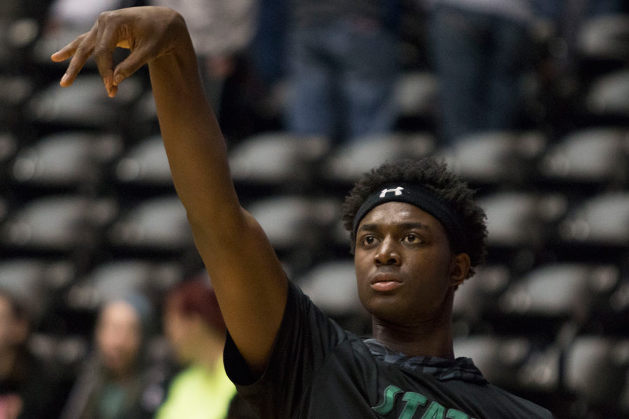 Senior Cameron Clark warms up before the game. Playing hard, smart and together is one of the mentalities we keep in mind, he said. With teammate Garret Luinstras help the two players scored 18 of the teams 23 points in the first half. 