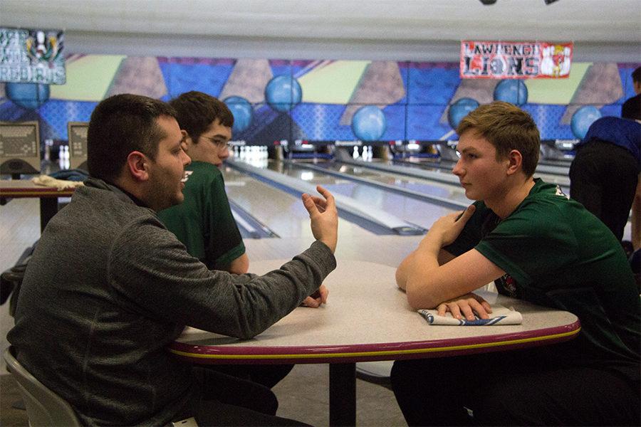 Listening to his coach Nick Campfield, sophomore Bayn Schrader discusses his bowling strategy. Schrader joined the boys varsity bowling team freshman year and has lettered both years. “I’ve done the high school leagues through Royal Crest in the summer since sixth grade and I’ve been bowling since I was nine,” Schrader said.