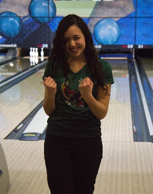 After bowling a strike, junior Emily Low celebrates. Low joined the bowling team halfway through the winter season on a whim. “Even though I started late, it has probably been one of my favorite Free State activities I’ve ever done because everyone was so nice and welcoming,” Low said.