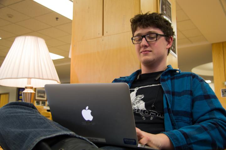 Working on an essay, junior Orson Becker types away on his MacBook Air. “An iPad is very limited in what it can do where a MacBook is more versatile,” Becker said.