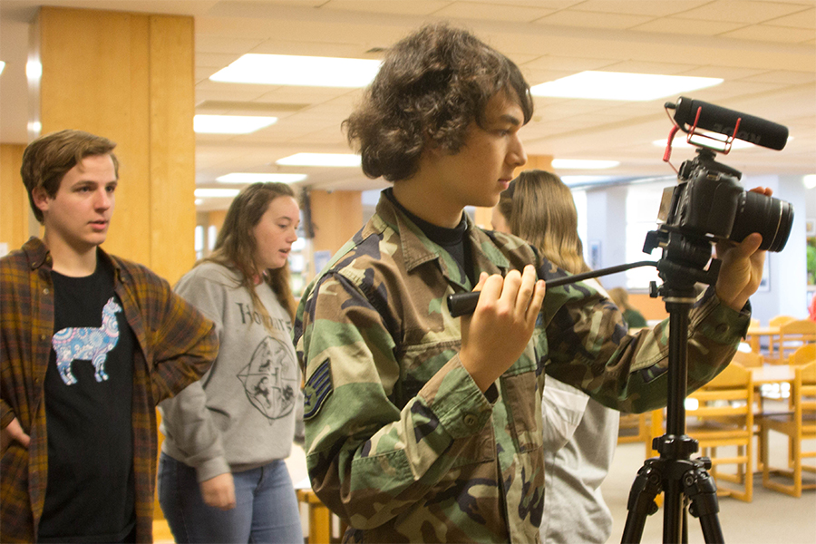 Juniors Max Ford and Ash Rantilla prepare to film a scene in the library.