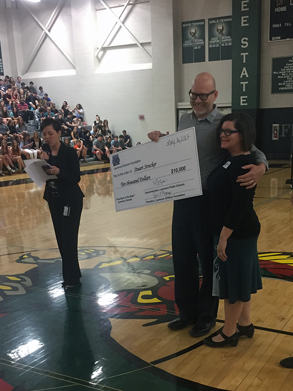 Lawrence Schools Foundation executive director Dena Johnston describes Streckers teaching achievement. The Bobs Award is actually $12,000, which comes out to $10,000 after taxes.