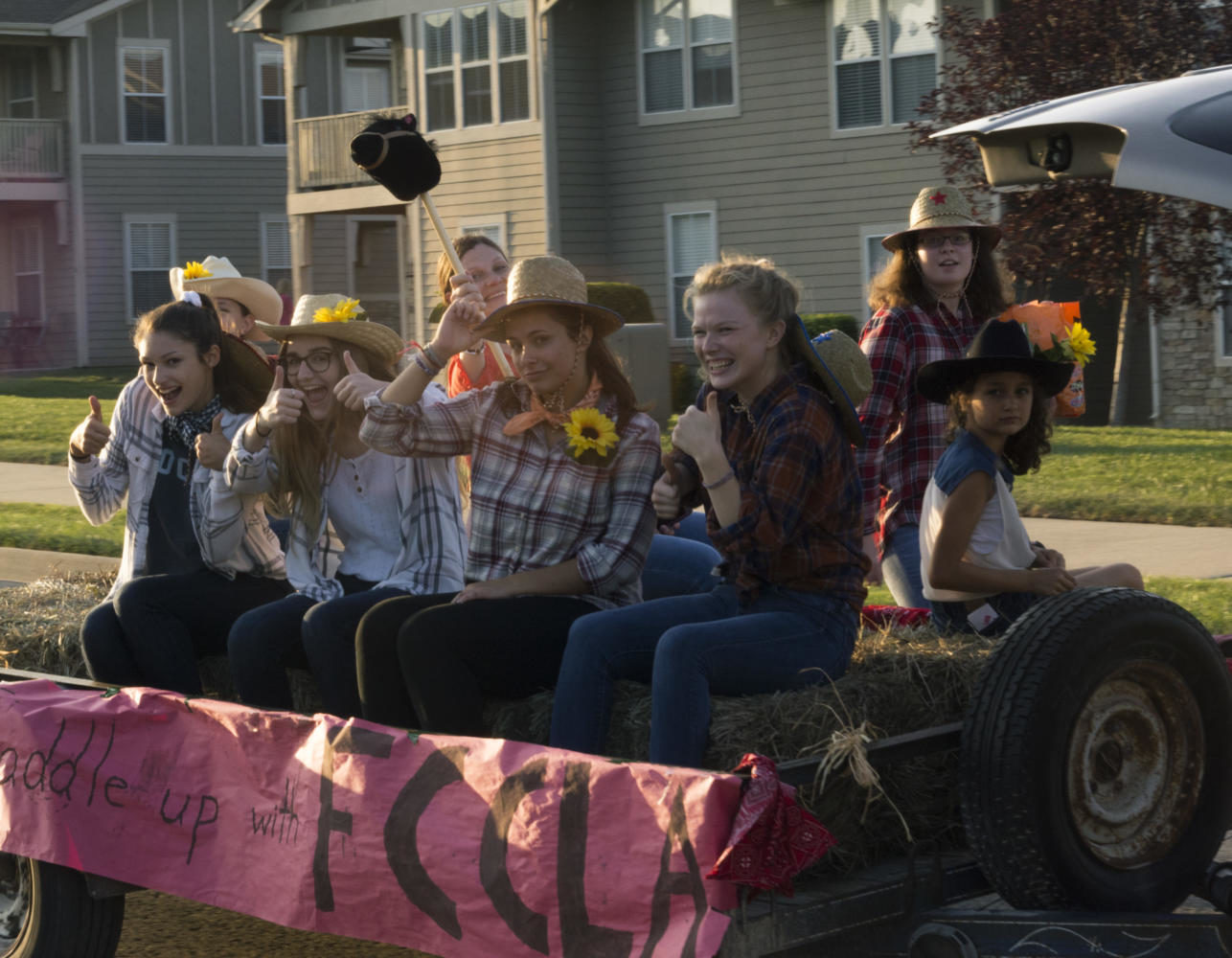 FCCLA members Caroline Kelton, Joplin Kean, Kaya Shafer, and Anna-Maya Hachmeister saddle up on their float. The homecoming parade began at Overland Dr. and Queens.