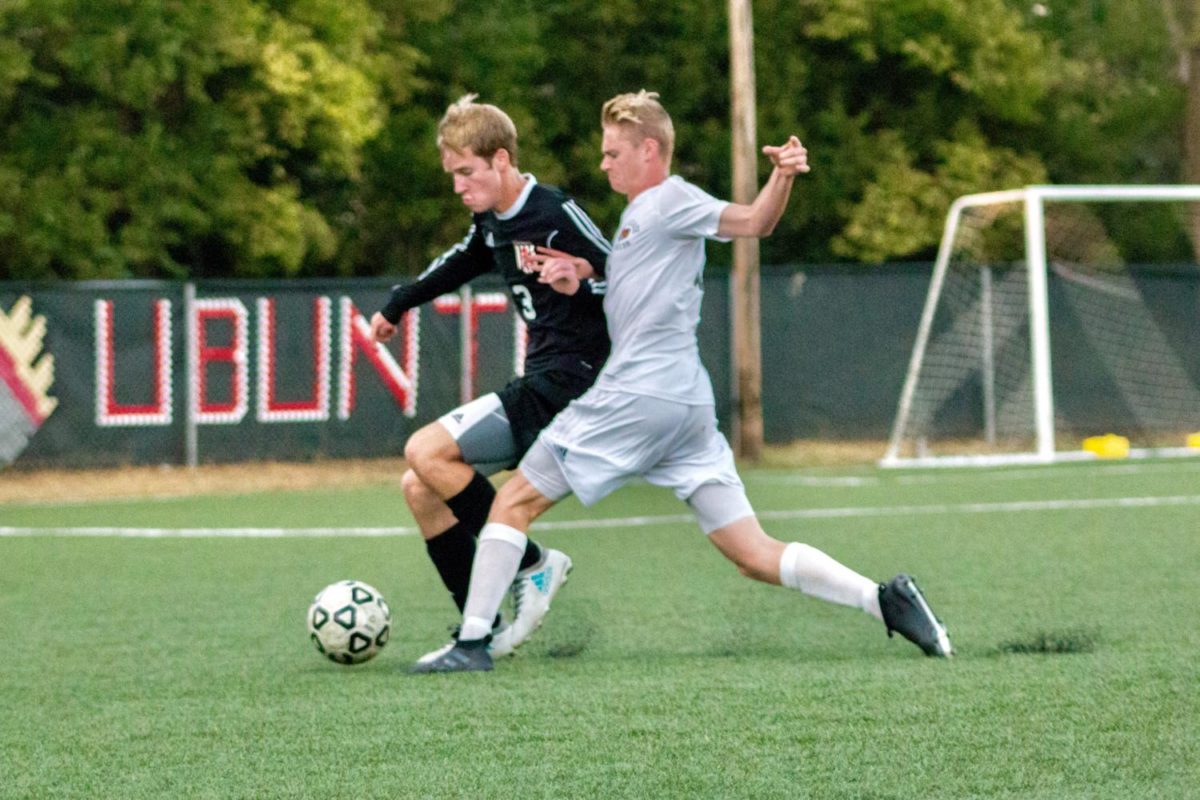 Fighting for the ball, senior Darik Dudley strives to overcome his opponent.