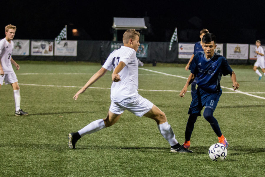 Junior Everett Waechter fights for the ball. Waechter made the second goal of the night 20 minutes into the first period. 